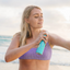 Woman applying sunscreen on a beach