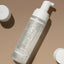 Skincare bottle with pump on a brown background